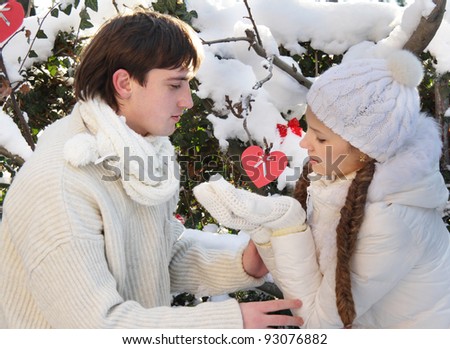young couple with artificial heart on natural background