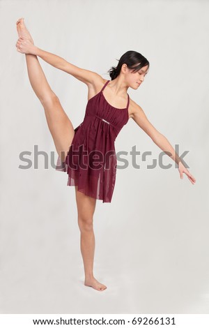 Asian Teenage Ballet Dancer stretching her leg