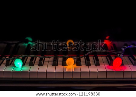 Piano keys with holiday lights