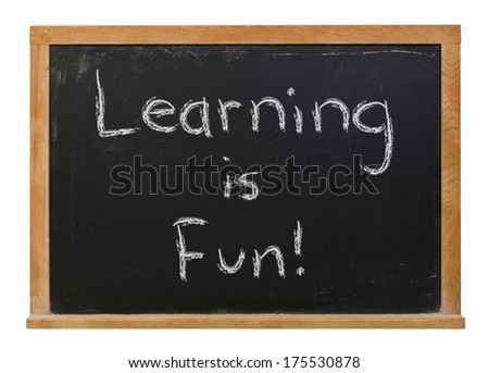 Learning is fun hand written in white chalk on a black chalkboard isolated on white