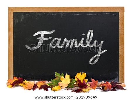 Family written in white chalk on a black chalkboard surrounded with fall leaves isolated on white