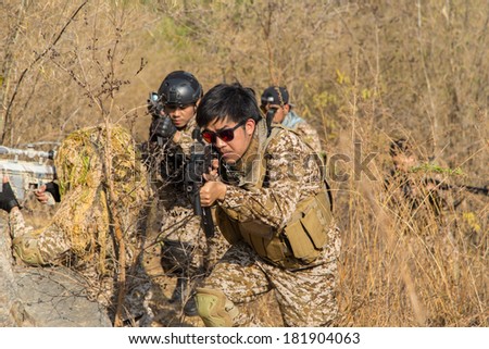 Asian men soldier training gun tactic
