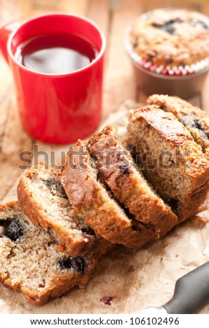 Freshly baked banana  and blueberry bread slices with a cup of coffee in vertical format