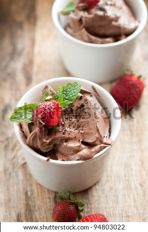Chocolate Mousse topped with Mint leaf and Strawberries in a white cup