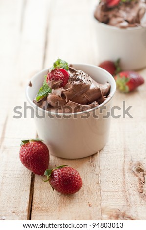 Chocolate Mousse topped with Mint leaf and Strawberries in a white cup