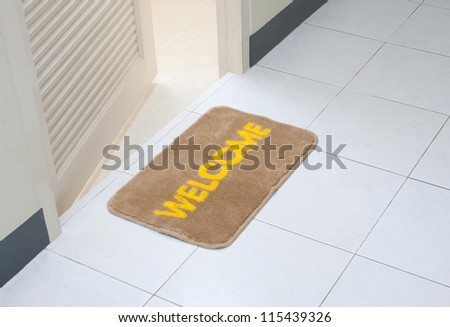 Welcome doormat in front of the rest room