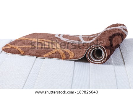 brown carpet rolled up on white carpet