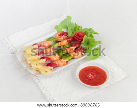 Shrimps and vegetables on barbecue sticks ready to serve