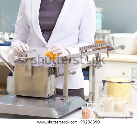 A pharmacist preparing medication with packaging capsule machine