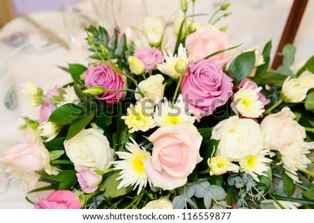 Pink and purple flowers decorate wedding reception