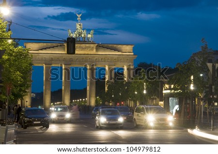 night scene Brandenburg Gate lit with car pedestrian traffic at night on Unter den Linden Berlin Germany Europe - stock photo night scene Brandenburg Gate lit with car pedestrian traffic at night on Unter den Linden Berlin Germany Europe - stock photo