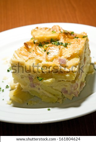 Czech Republic food specialty baked sliced potato with smoked bacon bits photographed in Prague Castle authentic typical delicacy