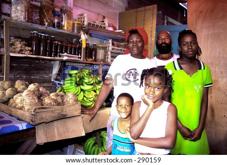native caribbean family in carraicou, grenada in their produce shop.