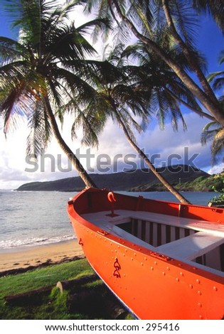 local concrete orange power boat on  beach in bequia, st. vincent & the grenadines, west indies.