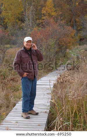 handsome man in wilderness on cell phone 228 smiling