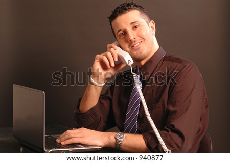 man on phone while on computer model released