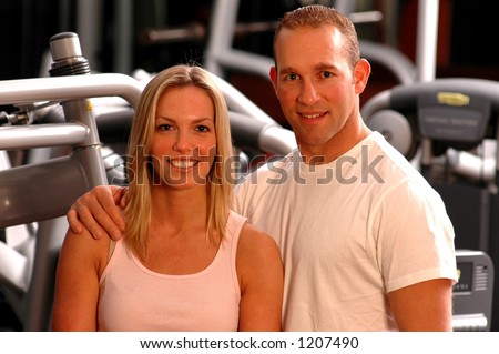 good looking couple in fitness center gym