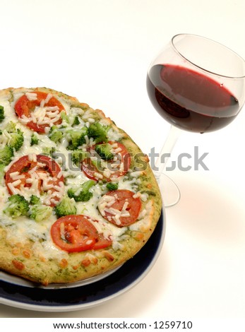 organic pesto pizza pie with glass of red wine