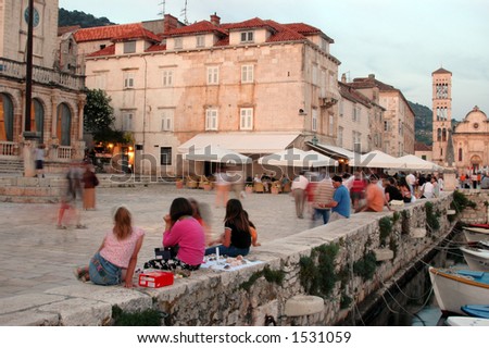 hvar  croatia dalmatian islands european harbor town at dusk with tourists boats and ancient architecture