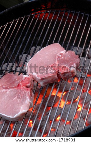 pork chops cooking on the kettle grill