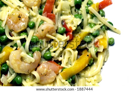 shrimp scampi linguini pasta with garden peas red yellow peppers garlic butter sauce in pan