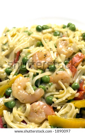 shrimp scampi linguine pasta with garden peas red yellow peppers garlic butter sauce in pan