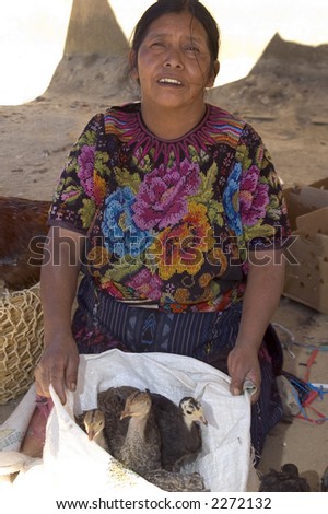 fowl duck vendor market with gold teeth chichicastenango guatemala