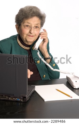 happy senior citizen office executive at desk with computer
