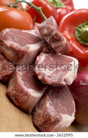 rib lamb chops meat prime cut with vegetables on cutting board