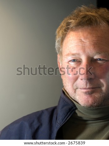 handsome man looking to the future with smile and positive outlook middle age