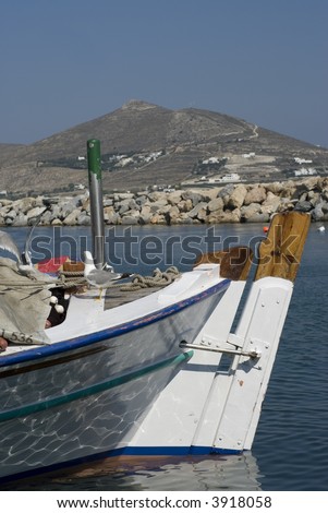 fishing boats in the greek islands cyclades aegean sea detail bow woodwork with sea gulls on boat