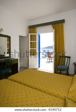 greek island hotel suite room with view of beach and cyclades architecture from hotel suite patio