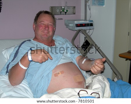 smiling happy patient in hospital bed pointing at incisions after appendectomy operation