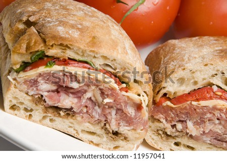 gourmet sandwich prosciutto ham asiago cheese with roasted peppers arugula lettuce on italian ciabatta bread