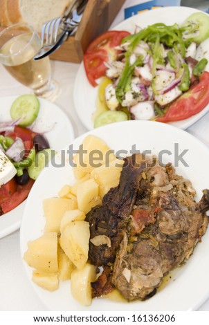 lamb in the paper dinner with greek salad octopus salad house wine greek island taverna restaurant specialty photographed in santorini, cyclades islands greece