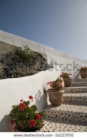walkway to sea with flowers inlaid stone architecture santorini greek island greece mediterranean