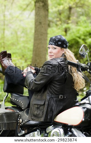 pretty woman on classic vintage motorcycle