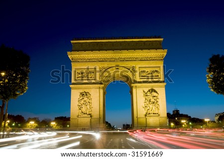 arc de triomphe arch of triumph at night with car streaks in the center of the Place Charles de Gaulle also known as Place de\'l Etoile in Paris France on the Champs-Elysees