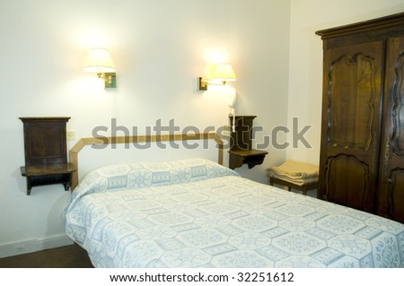 typical two star hotel room in paris france with armoire furniture