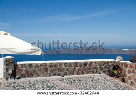 stone patio view in imerovigli santorini of volcanic island  with classic whitewashed buildings over the caldera on the mediterranean sea greece