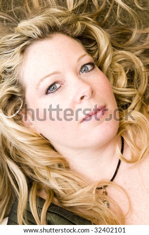 pretty middle age woman with blond hair and big blue eyes with hair loose