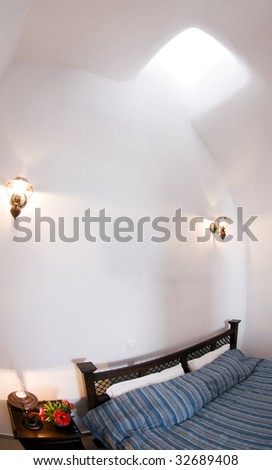 a bedroom in a santorini greek island traditional house built in a renovated cave house on the caldera mountains of town of oia