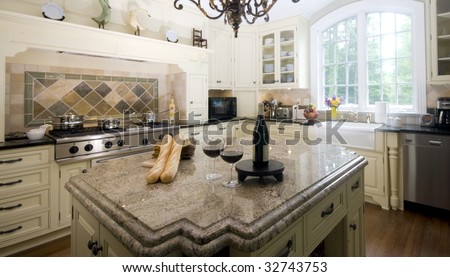luxury home modern custom kitchen with wine and baguettes on center island