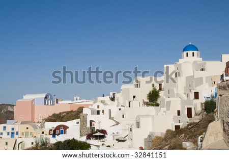 oia santorini view with blue dome greek church and typical cyclades island architecture of cave houses homes and hotels in greece