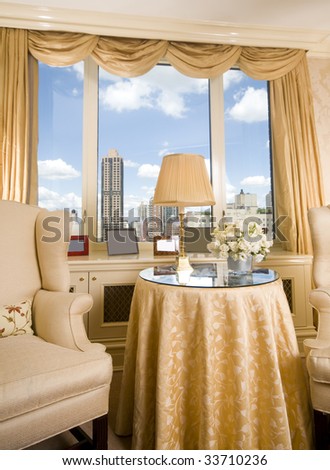 sitting area in luxury penthouse bedroom suite with skyline views of new york city