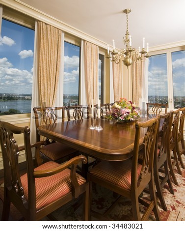 formal dining room in luxury penthouse apartment with view of city and river