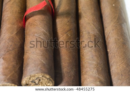box of quality hand made churchill size large cigars produced in Nicaragua Central America with red ribbon to remove one cigar
