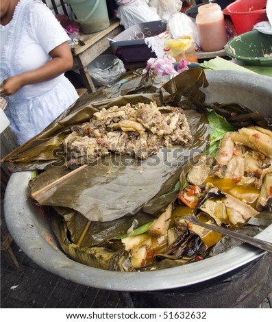 Beef and stewed yucca with banana tree leaves and  vegetables available for sale in street food market Leon, Nicaragua