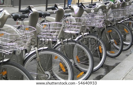 group of rental bicycles in row on the street Paris France