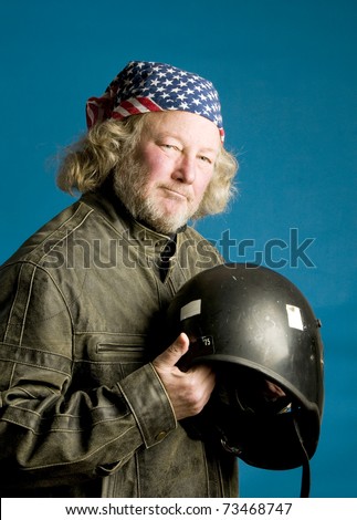 long hair senior motorcycle man wearing leather jacket and American flag bandana motorcycle helmet
